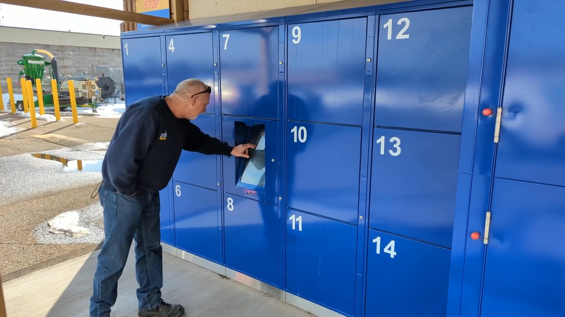 Doug Haas interacts with the computer panel on his rental lockers. 